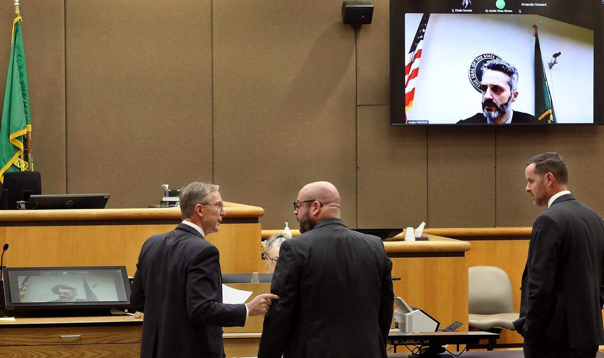 Benton County Commissioner Will McKay, right, looks on as his defense attorney Nick Jones, speaks with Assistant Attorney General Steve Garbin. The court hearing was conducted by Adams County Judge Peter Palubicki via a video link. 