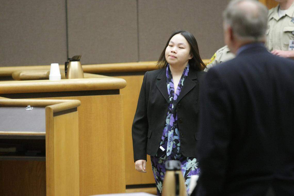 Phiengchai Sisouvanh Synhavong walks past Benton County Prosecutor Andy Miller during the second week of testimony in her trial for aggravated first-degree murder.