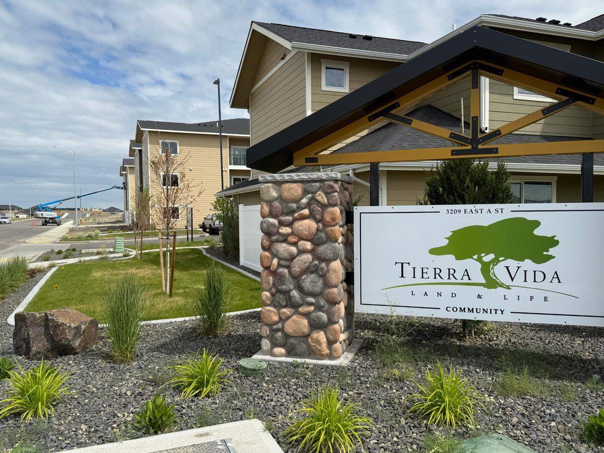 Construction of Tierra Vida Phase 3, a 120-unit apartment complex, is nearing completion in east Pasco. Above, a lift boom raises equipment to workers at the Jubilee Foundation community.
