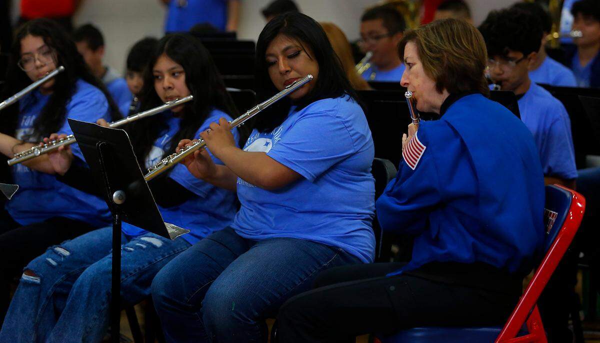 Ellen Ochoa, veteran astronaut and former director of NASA’s Johnson Space Center, plays her flute with band students while they perform the school’s fight song at Pasco middle school that is her namesake during a morning assembly. During her fifth visit to the school since the school opened in 2002, orchestra students performed “Reach for the Stars.”