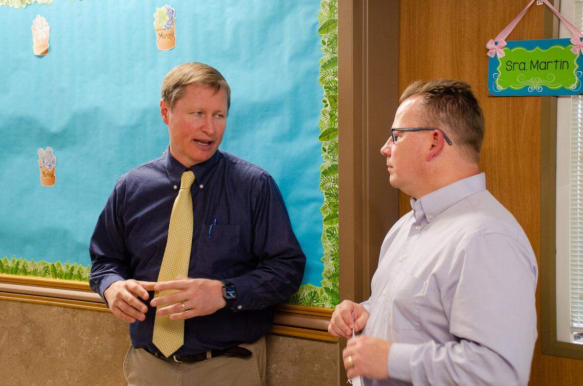 Washington State Superintendent Chris Reykdal, right, speaks with McClintock STEM Elementary assistant principal Scott Raab on Friday afternoon during a visit to the school’s dual language classrooms, where students learn various subjects in both Spanish and English.