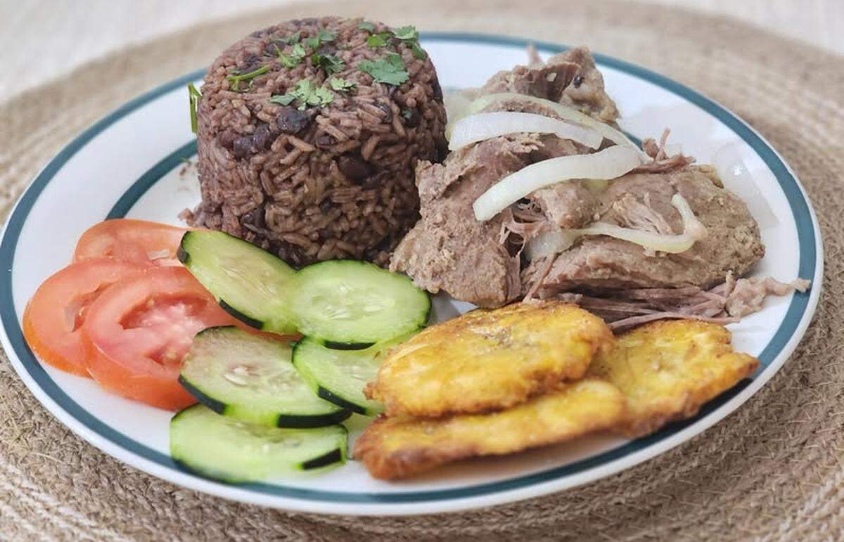 Roasted pork with rice and beans, salad and twice-fried green plantains, at Cuba Libre Tri-Cities, a new food truck serving Cuban cuisine in Kennewick.