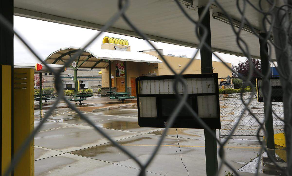 Temporary construction fencing surrounds the former Sonic Drive-In on Gage Boulevard in Kennewick. The city has approved a building permit to convert it to a Burgerville USA.