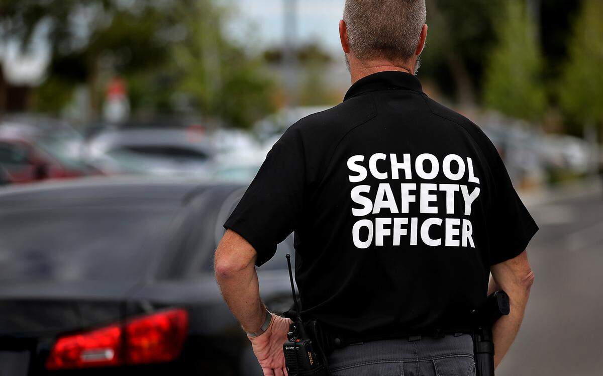 School Safety Officer Scott Child stands in the Amistad Elementary School parking lot on the first day of classes in Kennewick.