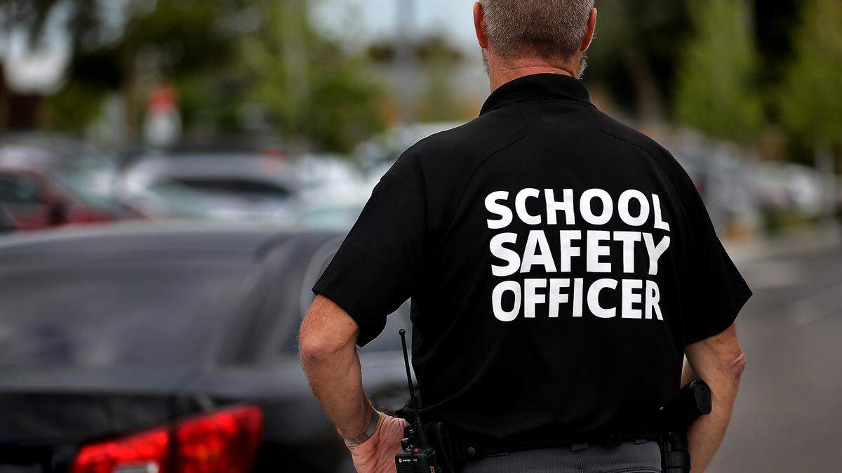 School Safety Officer Scott Child stands in the Amistad Elementary School parking lot on the first day of classes of the 2023-24 school year at the Kennewick school.