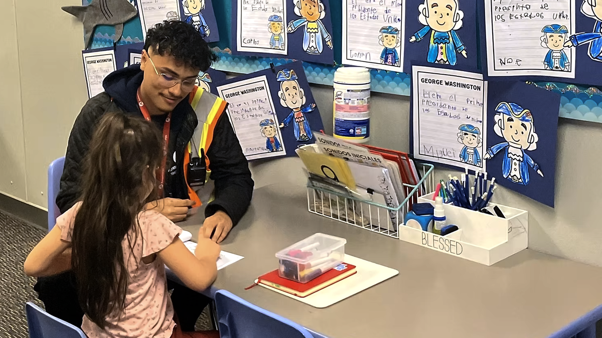 An AmeriCorps volunteer with Serve Tri-Cities tutors a student at a Pasco elementary school