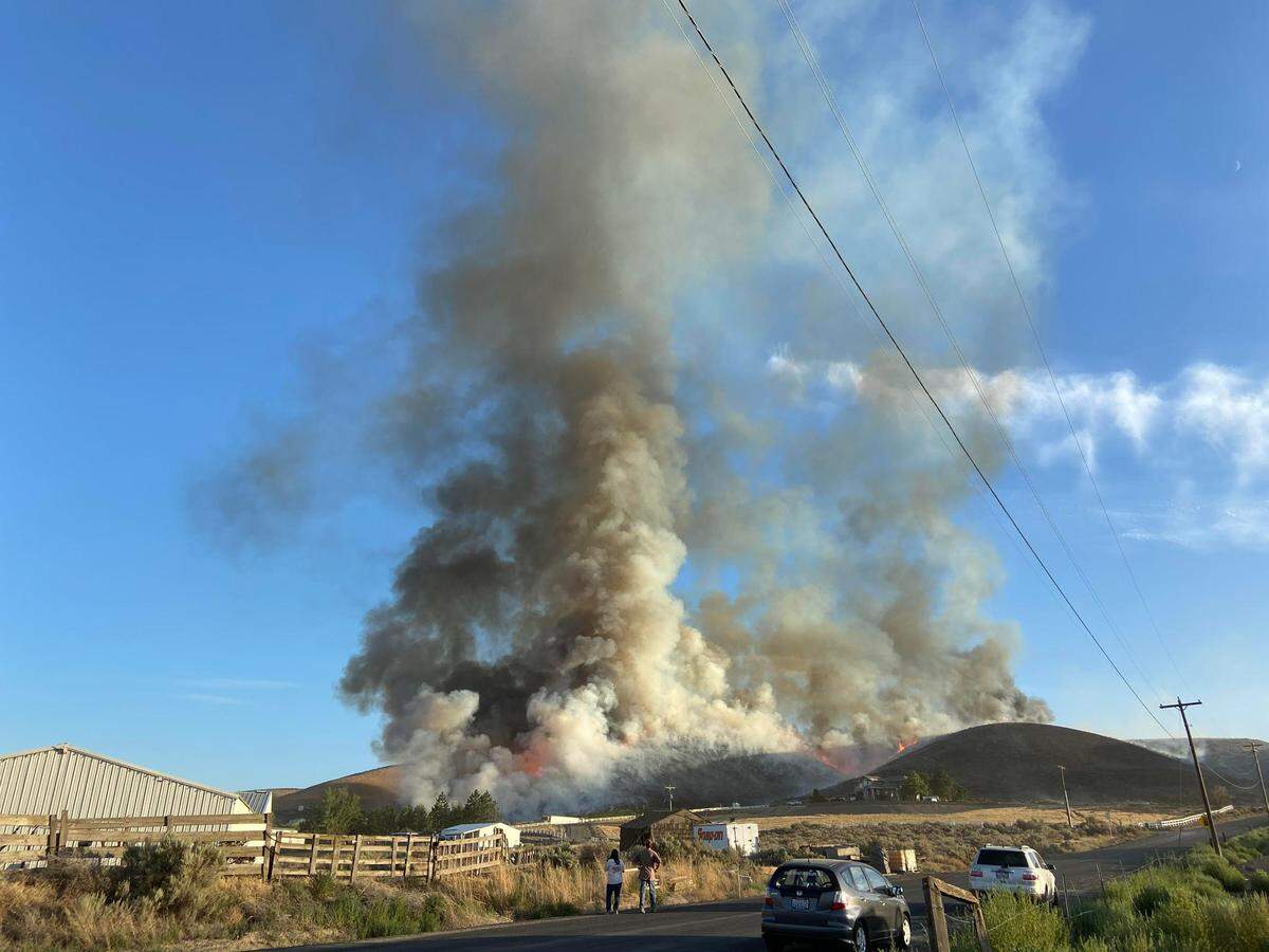 Firefighters from nine Tri-City fire agencies were battling a wildfire Friday evening near Badger Canyon Road.
