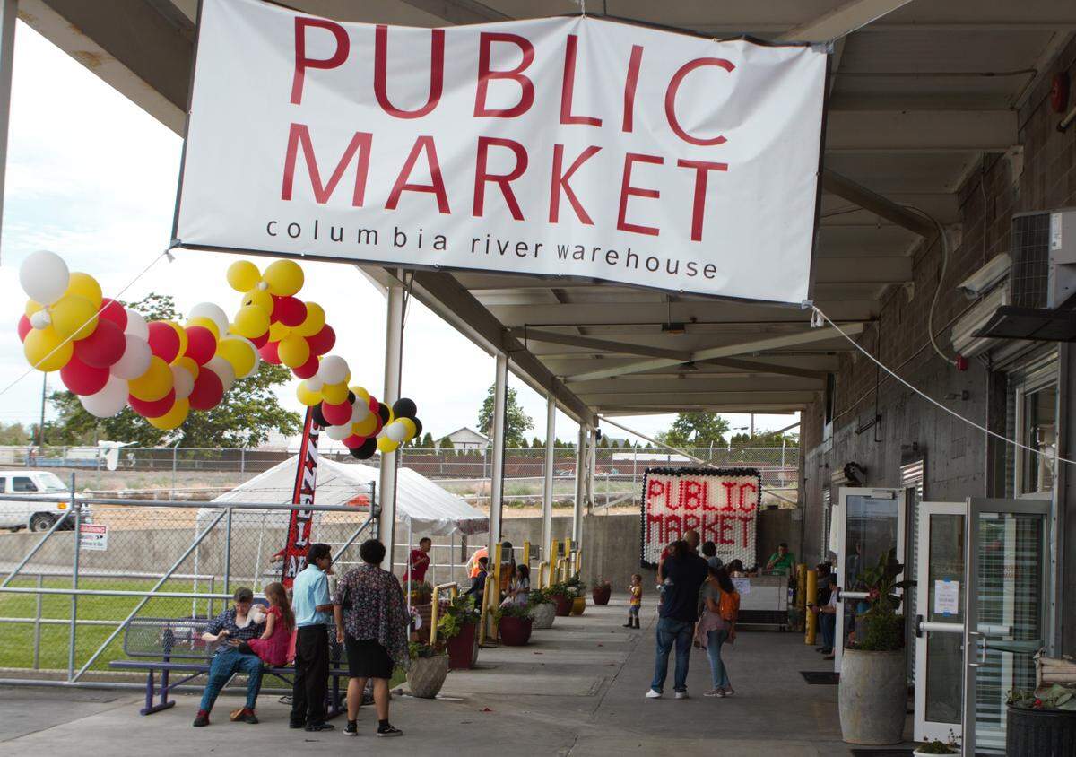 Signs and balloons mark the grand opening weekend for the Public Market at Columbia River Warehouse. The market is now open, at 10 E. Bruneau Ave. in downtown Kennewick.