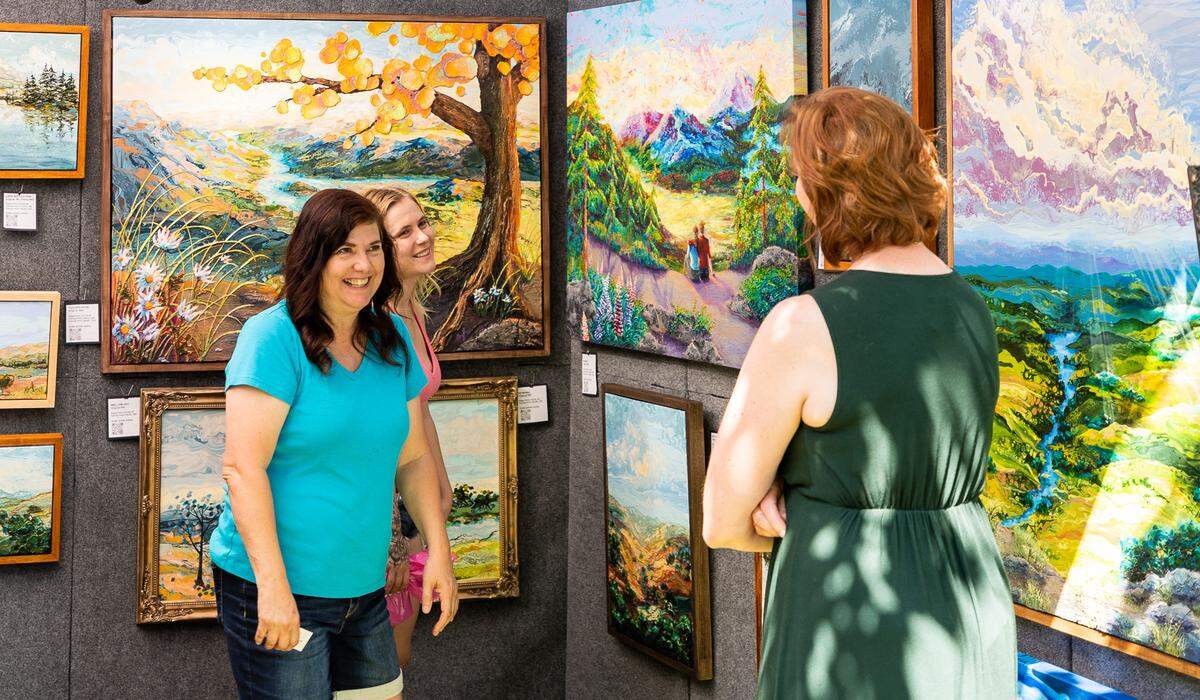 Artist of abstract landscapes, Calista, shows the beauty of her travel adventures in her acrylic and oil painting. She is one of the artists selling her artworks at the Art in the Park Festival.