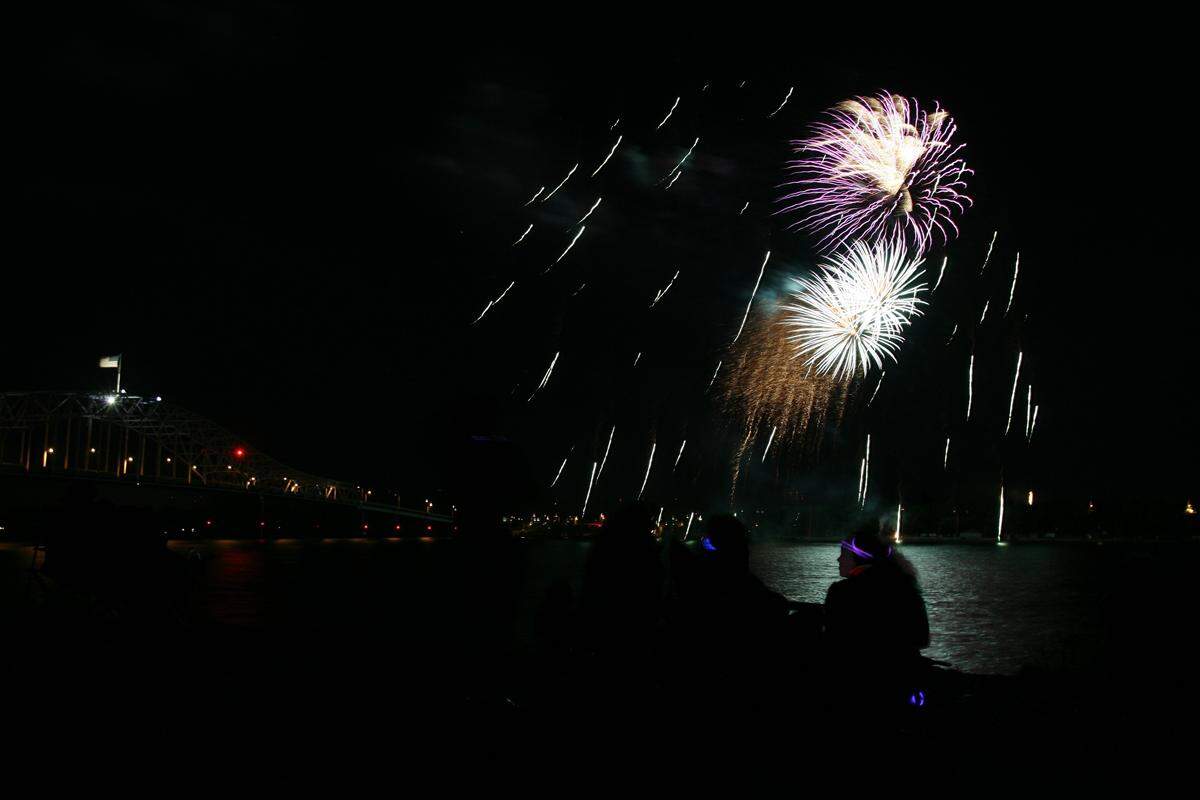 People line both sides of the Columbia River to watch the fireworks display that caps off the daylong River of Fire Festival at Columbia Park.