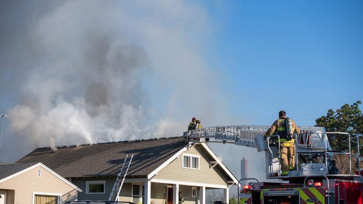 Pasco firefighters work to control a fire that spread from an abandoned house to this occupied home at 920 S. 5th Ave. shortly before 7 a.m. Saturday. Everyone got out safely, said Ben Shearer with the Pasco Fire Department.