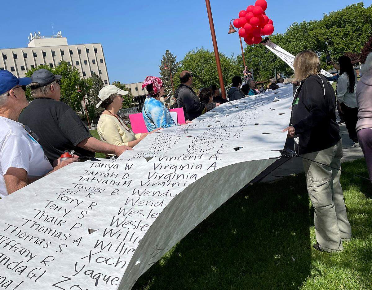 The names of hundreds of voters who signed a petition urging Rep. Dan Newhouse, R-Wash., to protect Medicaid and Apple Health from deep cuts were attached to balloons in April 2025 in Richland.
