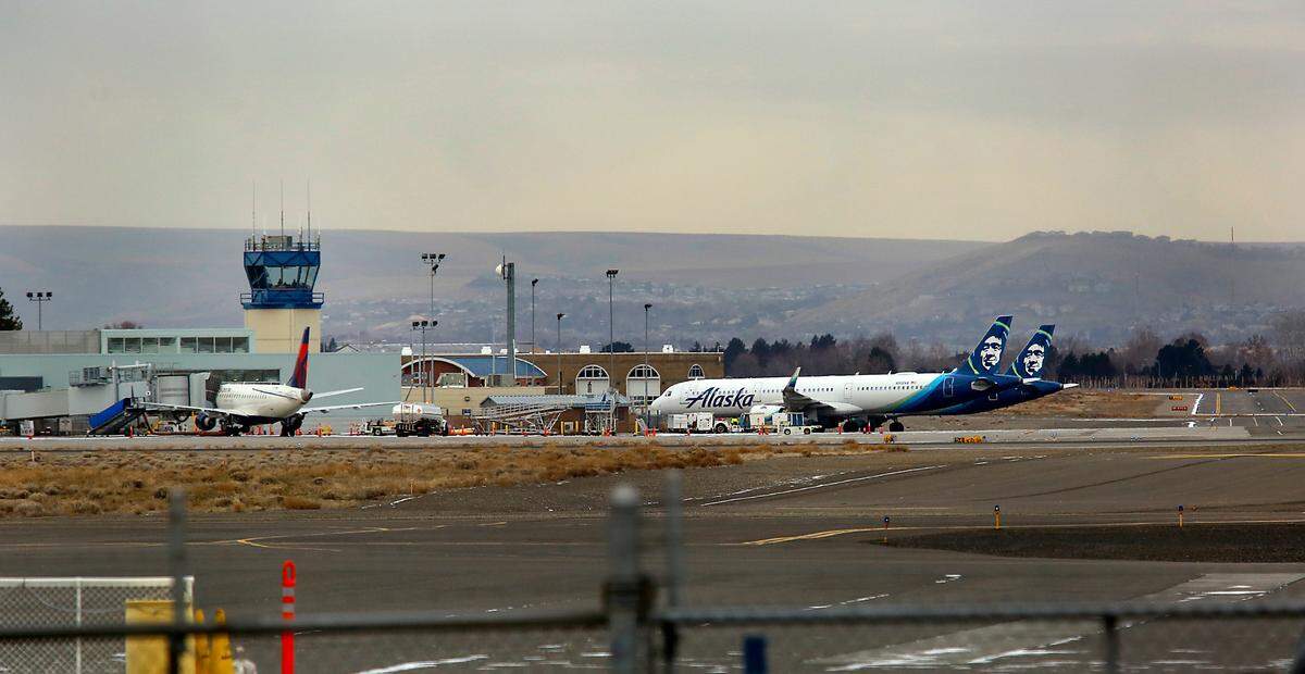 Two Alaska Airlines jet planes sit on the Tri-Cities Airport tarmac Monday morning after being diverted to Pasco Sunday night, according to Tri-Cities Airport Director Buck Taft. The diversions came as the Seattle-Tacoma International Airport was forced to cancel 364 flights because of winter weather.
