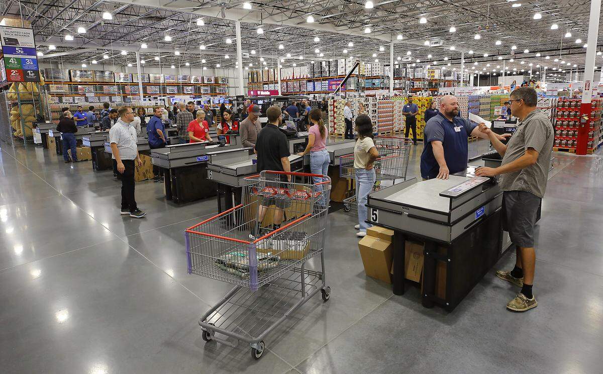 Members pay for their purchases after the doors opened to customer for the grand opening of the new Costco Wholesale store at 3125 Queensgate Dr. in Richland.