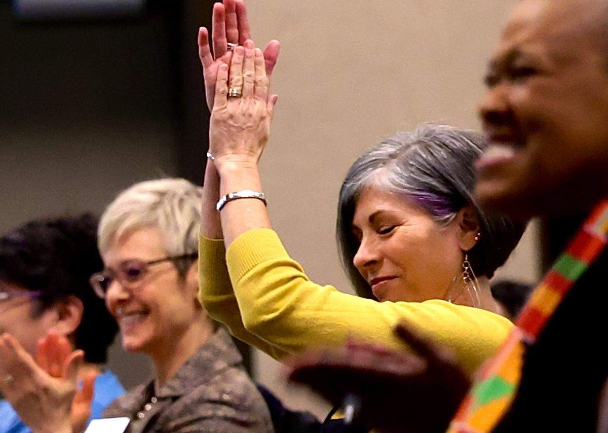 Lynn Carlson, the 2025 Martin Luther King Jr. Spirit Award recipient, claps along during songs performed by the Tri-Cities Community Choir at the Martin Luther King Jr. Day bell-ringing ceremony at Columbia Basin College in Pasco.