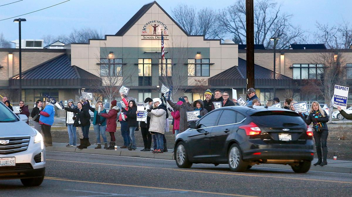 Kennewick School District paraeducators, cashiers, classified employees and family members rally early Thursday near the district offices. The 600-plus workers, represented by Public School Employees of Washington SEIU Local 1948, and the district have been negotiating over pay for months and they plan to vote Jan. 17 on whether to strike.