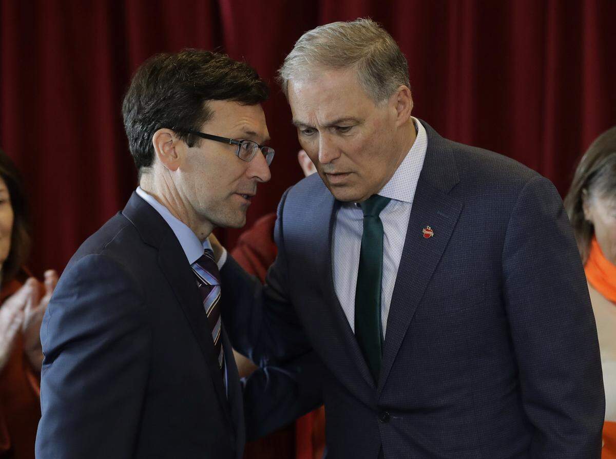 Washington Gov. Jay Inslee, right, and Attorney General Bob Ferguson support a state law that took effect in June 2018 to help more ill Hanford workers get their compensation claims approved.