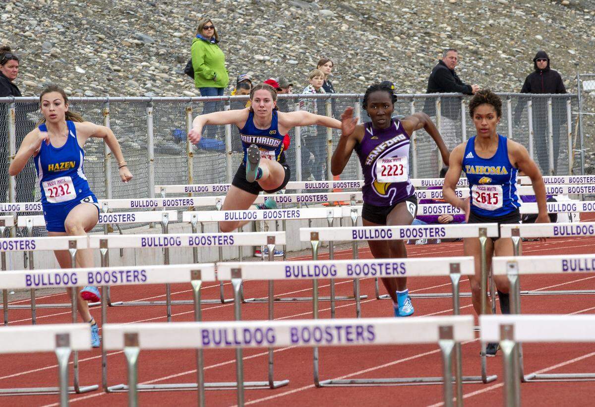 Onlookers watch as athletes compete in the girls 100 meters hurdles during the 58th Pasco invite track and field meet on Saturday at Edgar Brown Stadium. Hanford’s Nyenuchi Okemgbo took third place in the 100 meter hurdles with a time of 15.11.