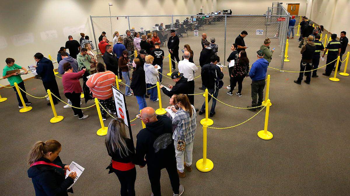 Dozens of Benton County citizens wait in line at the Benton County Election Center in Richland for voter registration and replacement ballots on Election Day. 