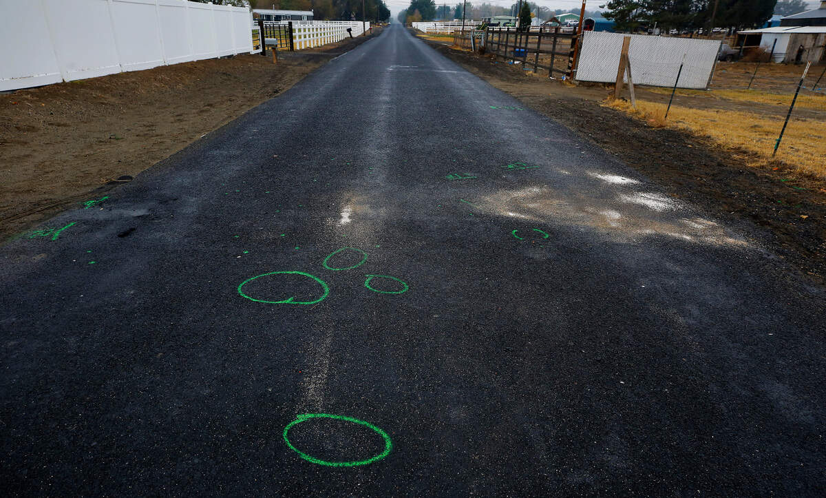 Benton County Sheriff’s Office investigative paint markings cover the pavement on South Dague Road where two ATV riders collided and died Sunday night in Finley.