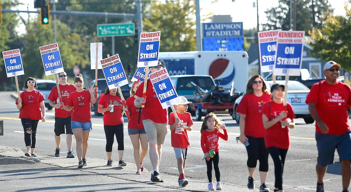Striking Kennewick teachers and their supporters walk on West Vineyard Drive early Tuesday morning near Amistad Elementary School.