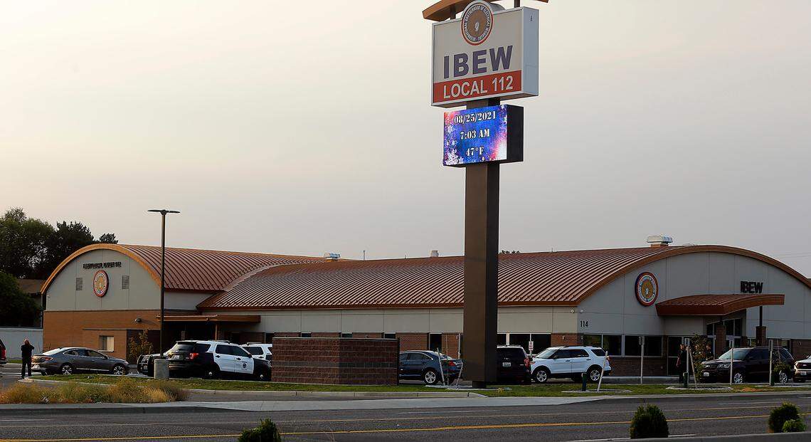 Multiple law enforcement vehicles are seen in the parking lot of the IBEW Local 112 building early Wednesday morning on North Edison Street in Kennewick.
