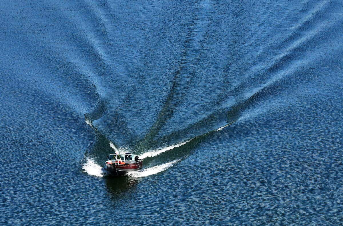 A boater on the Columbia River aims for the boat launch near the Columbia Park Marina in the west end of Columbia Park in Richland on a sunny spring day.