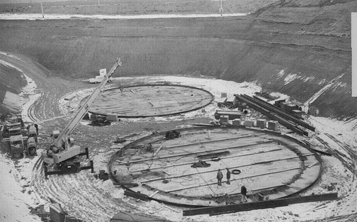 Construction as underway on Hanford double-shell Tank AY-102, in the foreground, in 1969. The first double-shell tank to be built, it sprang multiple leaks from its inner shell and was taken out of service.