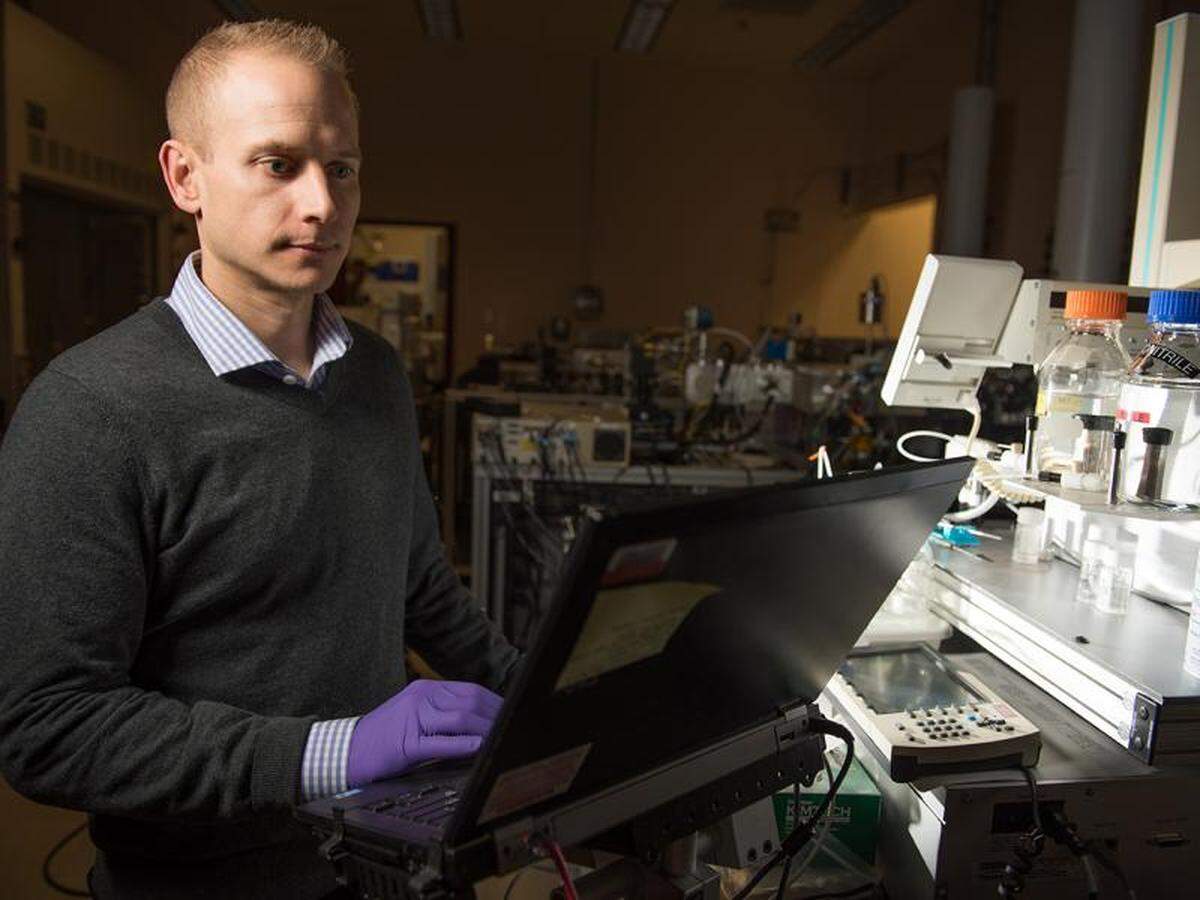 Paul Piehowski, a Pacific Northwest National Laboratory chemist, looks at protein measurements in a technique that is being used to study the proteins in the breath of Tri-Cities COVID patients to learn more about the disease.