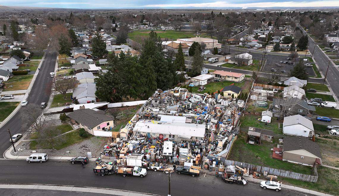 Richland has started clearing vehicles and other items blocking the sidewalk and street outside a house on Pullen Street in central Richland.