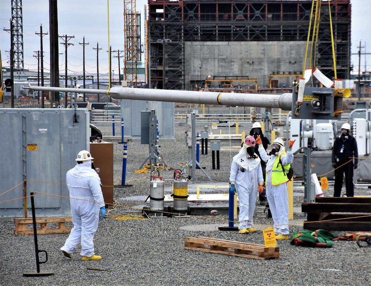 Washington River Protection Solutions workers install equipment to transfer waste from an underground tank at the Hanford site.