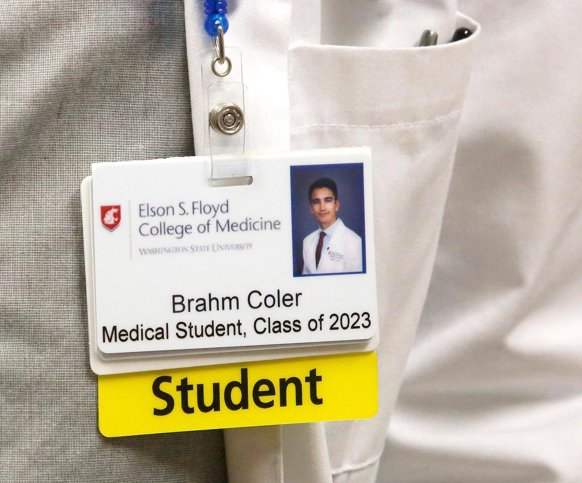 WSU medical student Brahm Coler wears an ID tag showing his student status while shadowing Dr. Naveen Rawat recently at the Kadlec Pulmonology Clinic in Richland.