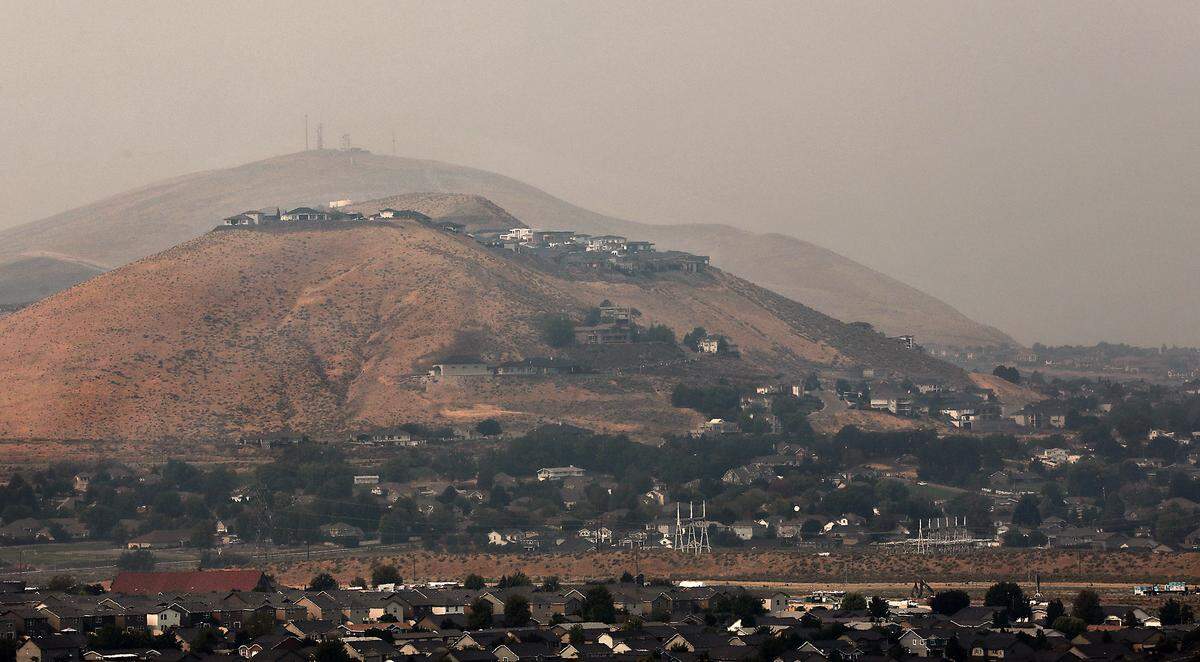 A blanket of smoke from wildfires burning acrss eastern Washington from settles on the Tri-Cities reducing air quality and visibility across the Mid-Columbia Region.