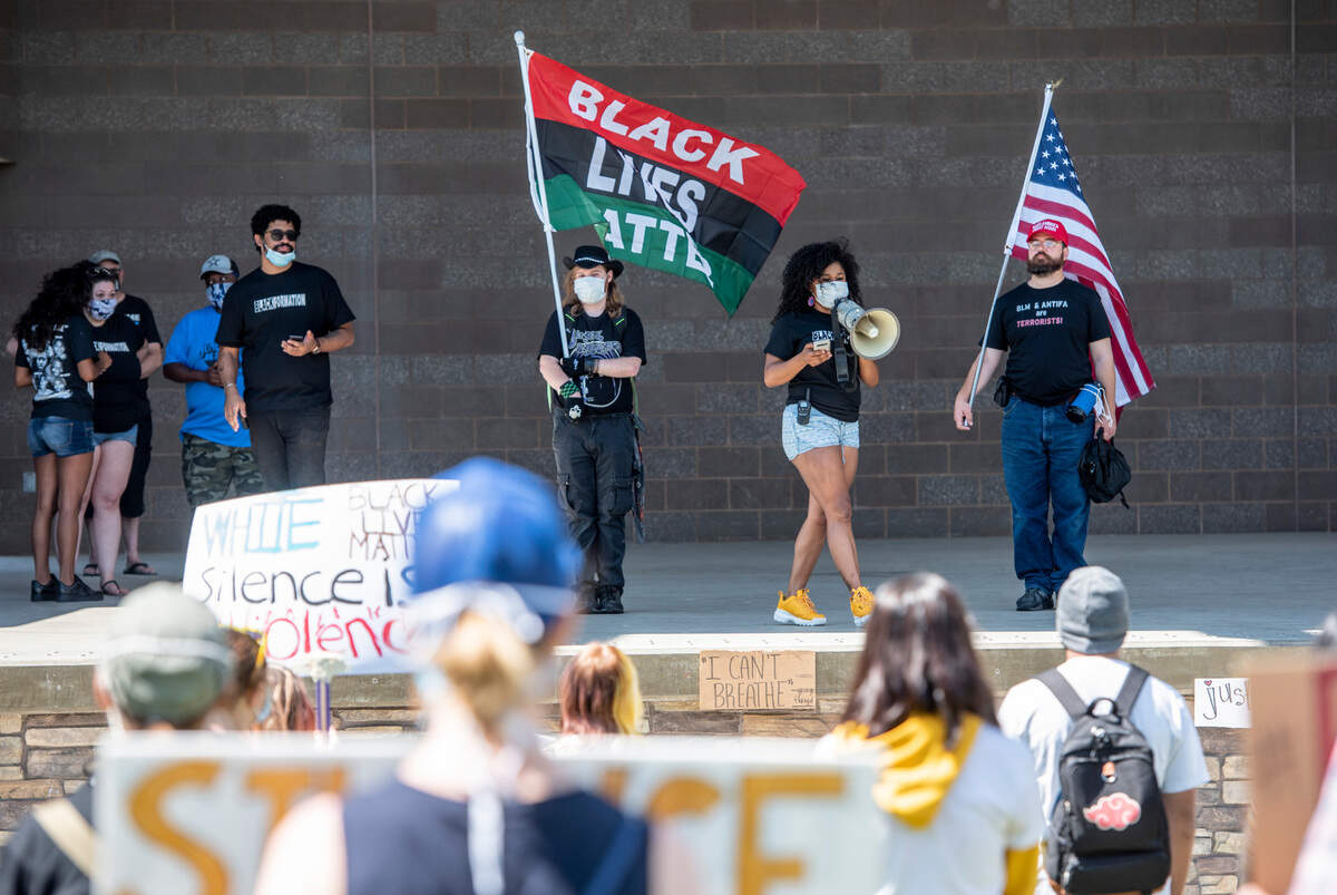 Organizer Amber Rodriguez speaks at a Black Lives Matter demonstration hosted by Blackformation in John Dam Plaza in Richland on the Fourth of July. While speaking, Rodriguez was flanked by a supporter, on her left, and a protester, on right, who stood on stage for the duration of the event.