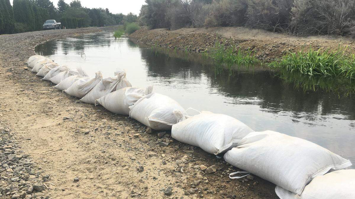 The Kennewick Irrigation District placed sandbags along parts of the Badger East Canal Tuesday morning after the canal overflowed in two places.