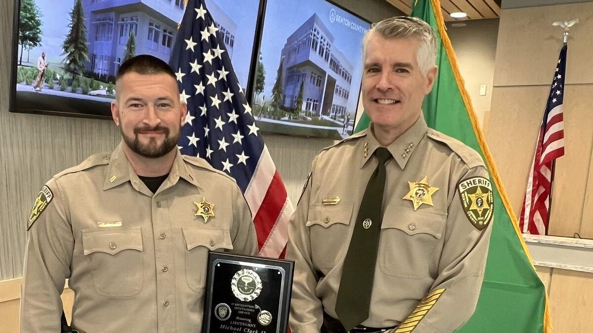 Benton County Sheriff Tom Croskrey, right, presents Lt. Mike Clark with a plaque recognizing his 11 years of service on the SWAT Team in 2023.
