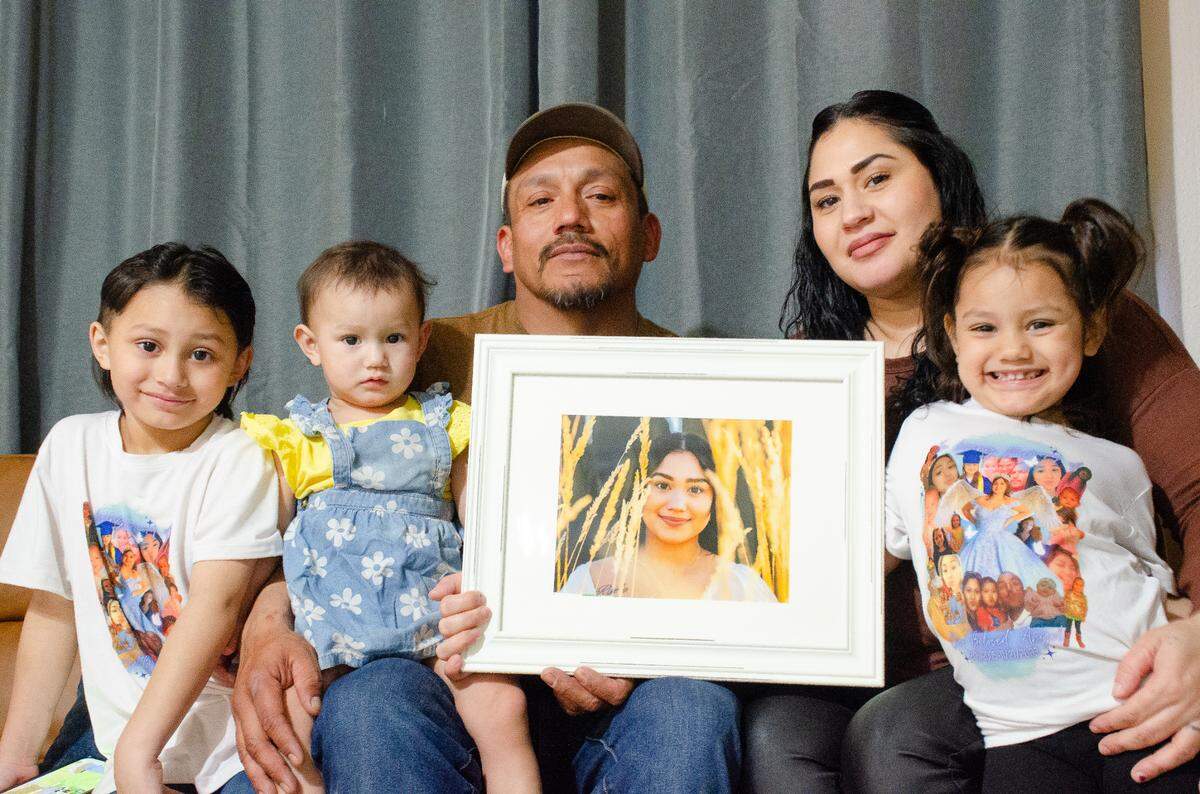 Gabriel Moreno and Angelica Reyes of Kennewick hold a photo in 2024 of their daughter, Maria, 17, who died in a car crash in November 2023. Their other kids are, from left, Gabey Jr., Cheyanne and Cherylnn.