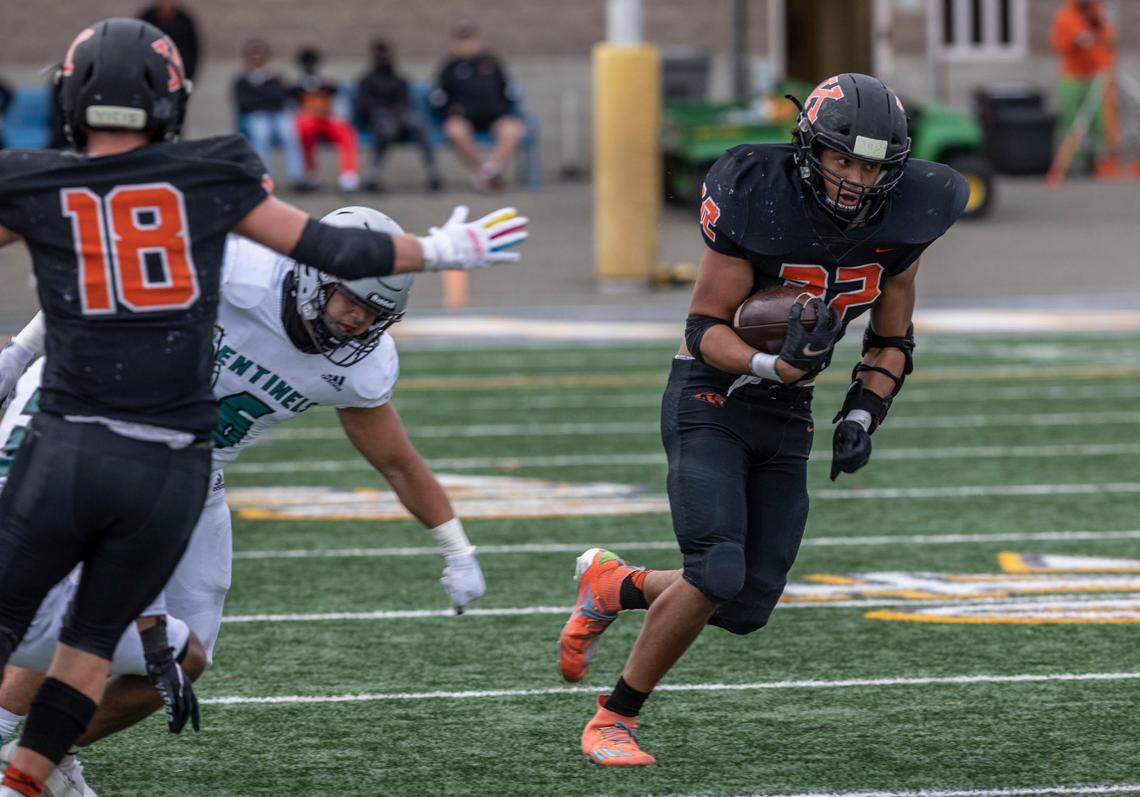 Kennewick senior Bronson Childs tries to gain some. yardage for the Lions during a playoffs game against visiting Spanaway Lake in Kennewick.