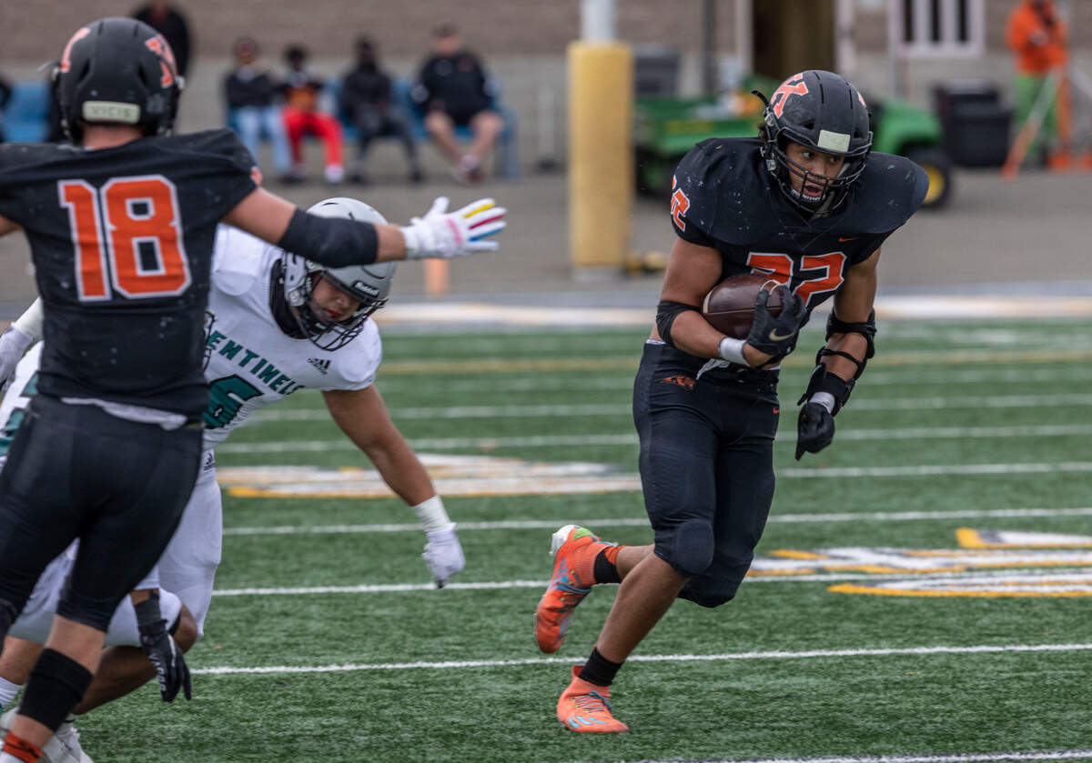 Kennewick senior Bronson Childs tries to gain some. yardage for the Lions during a playoff game against visiting Spanaway Lake in Kennewick.
