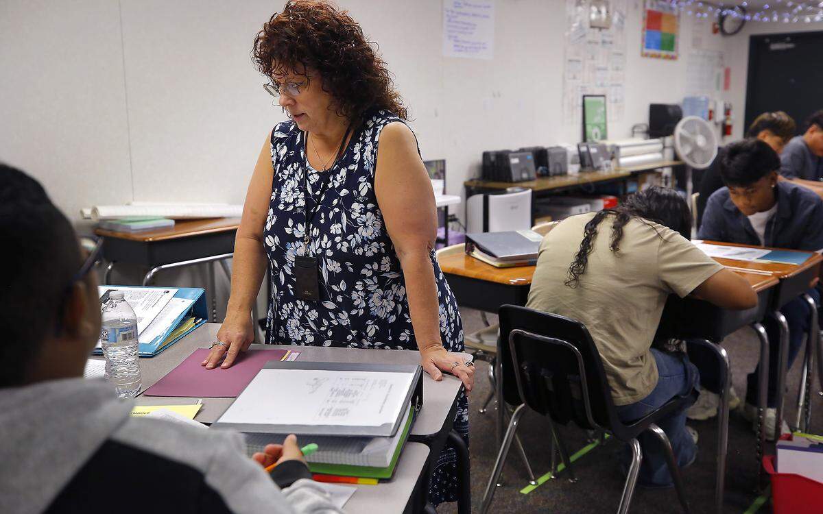 Teacher Francine Hicks helps her eighth-grade students with an assigment in her English and History class at Park Middle School in Kennewick.