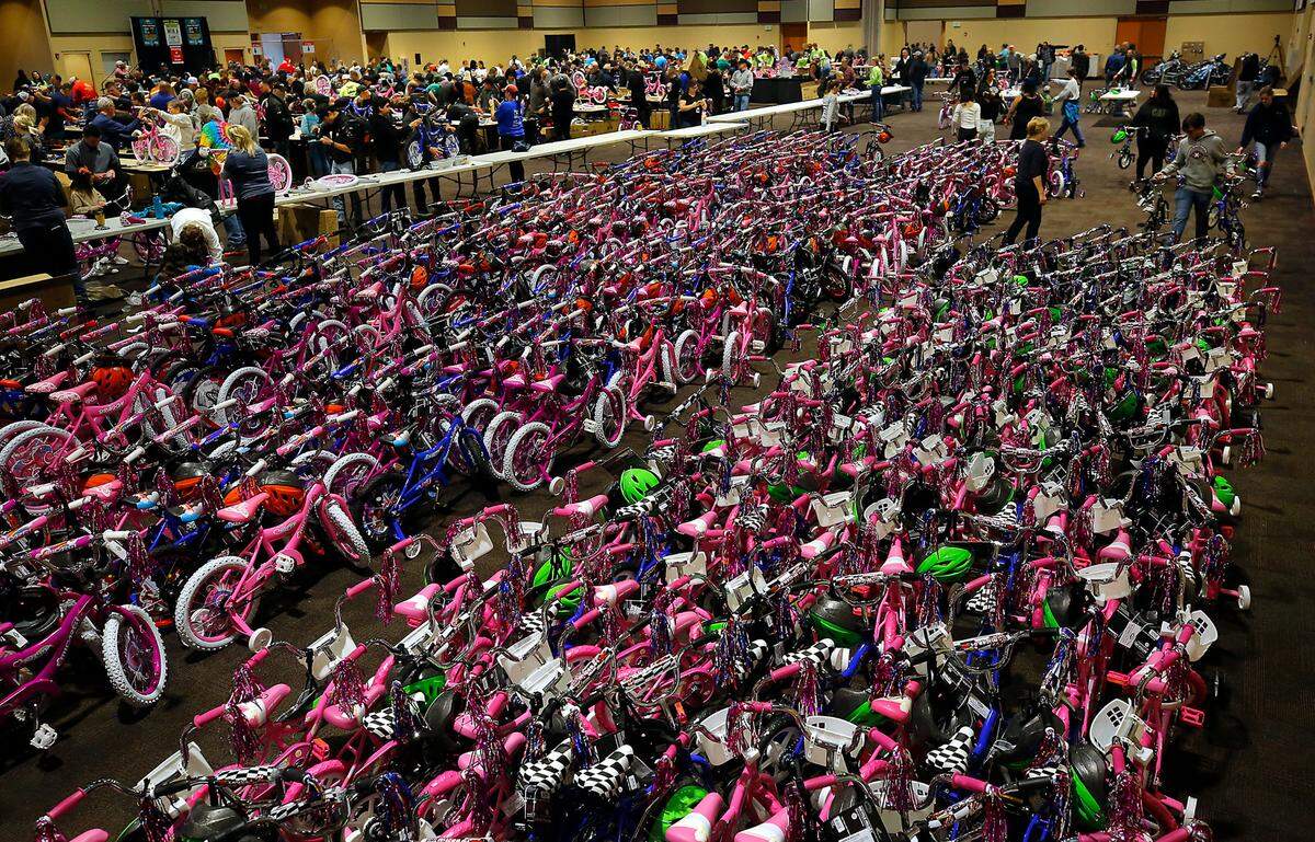 Community volunteers line up assembled bikes at the 14th annual Bikes for Tikes bike build event at the Three Rivers Convention Center in Kennewick. About 600 volunteers were on hand to build an estimated 1,600 bicycles in about four hours for distribution by various organizations to children in need throughout the Mid-Columbia. The Bikes for Tikes non-profit organization was founded in 2009 by the Plumbers & Steamfitters UA Local 598 and through this year have donated 20,000 bicycles. A safety helmet is also included with each bike.