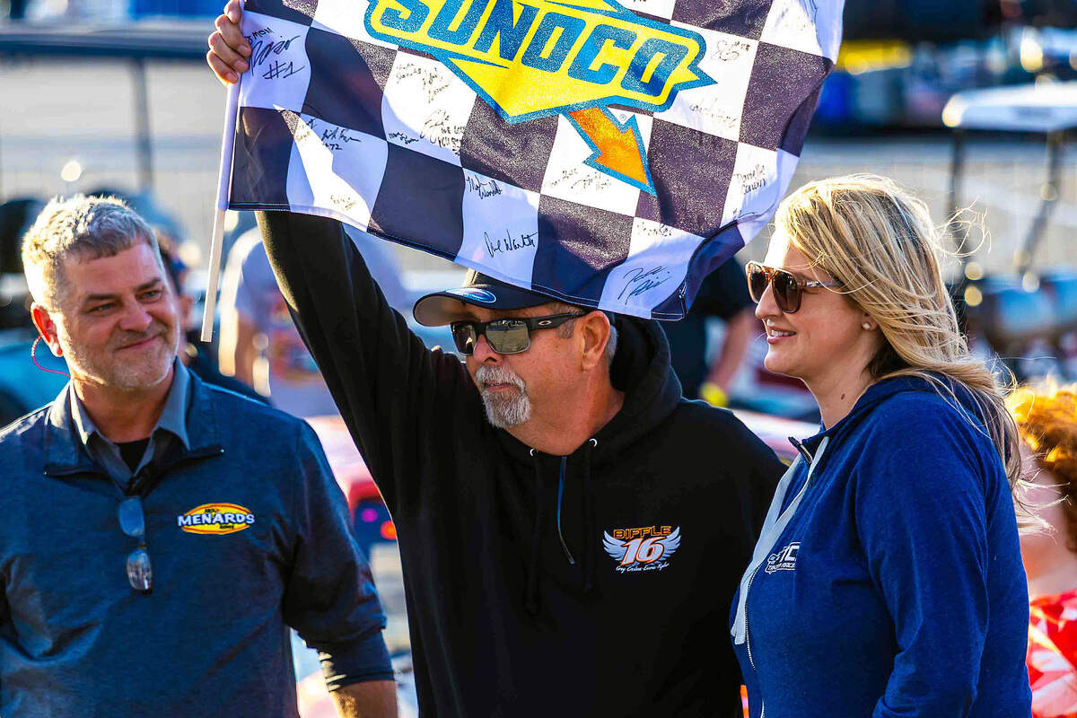 Members of Greg Biffle's family accept a commemorative checkered flag before the start of the NAPA Auto Care 150 Greg Biffle Memorial on Saturday at Tri-City Raceway in West Richland. The race honored the NASCAR star and former Tri-City Raceway competitor, who died in a plane crash in December 2025.