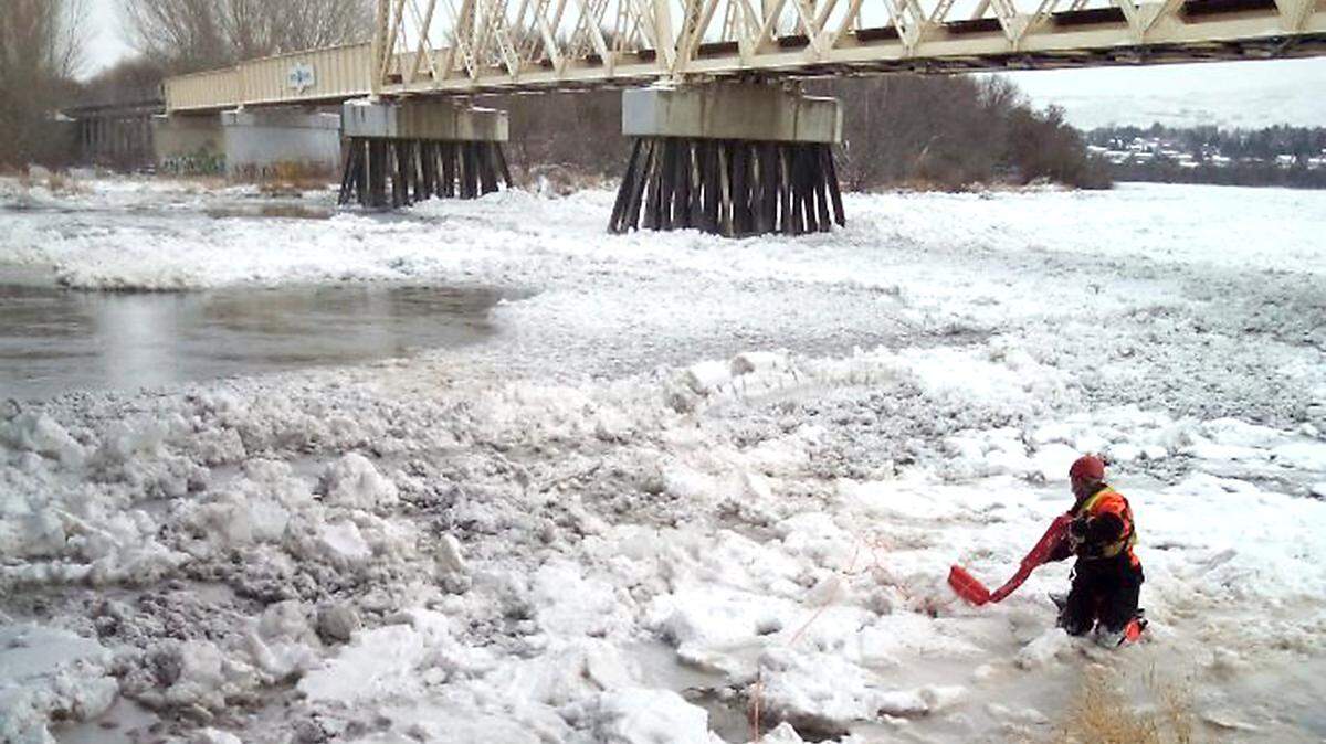 Members of Columbia Basin Dive Rescue respond Monday to a report of a deer stranded on the partially frozen Yakima River in Richland. The animal was able to make it safely off the ice before divers reached it.