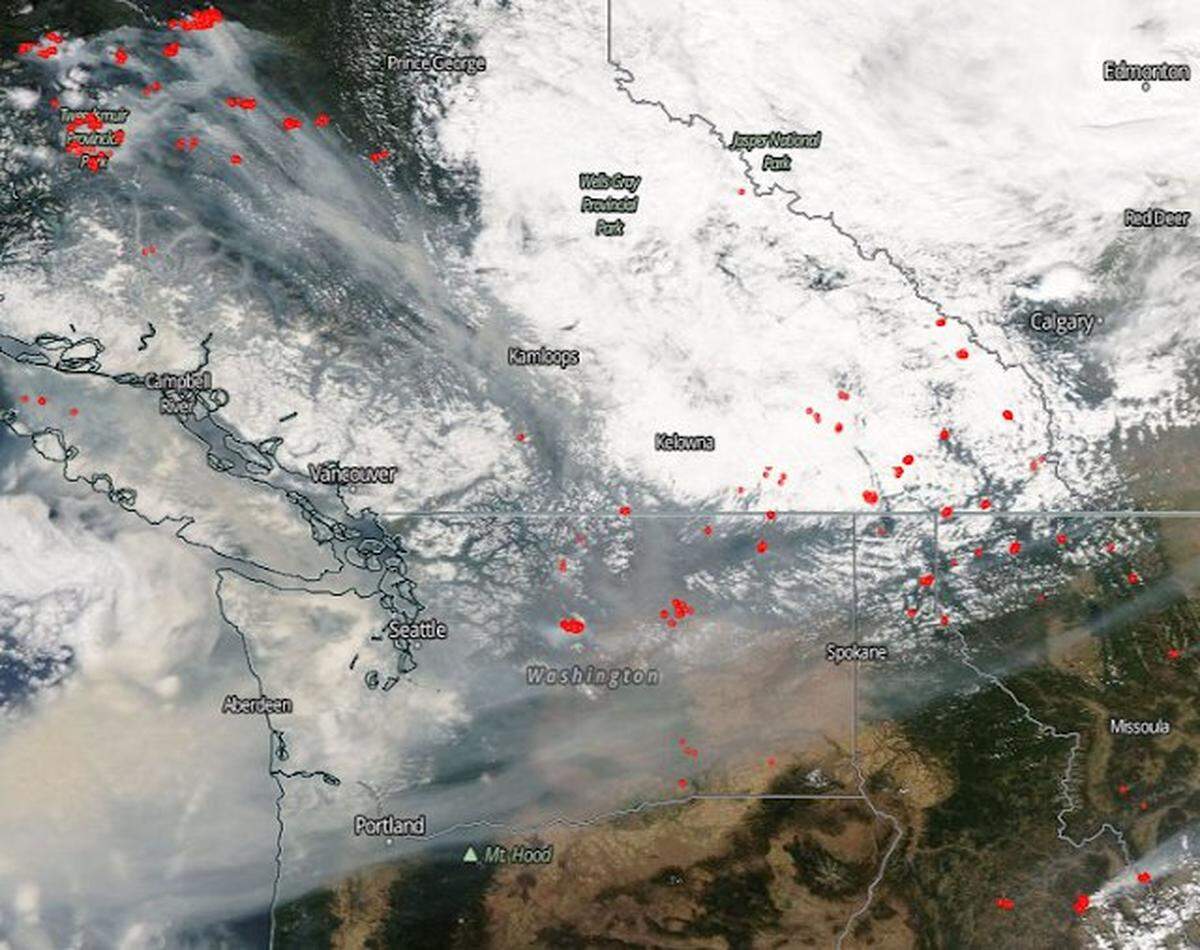 A satellite view of Washington state shows smoke from wildfires moving south over Eastern Washington.