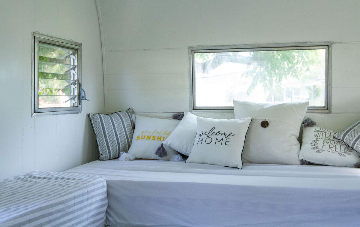 The white La Cantina Mobile Bar trailer has a lounge area for guests to relax and socialize.