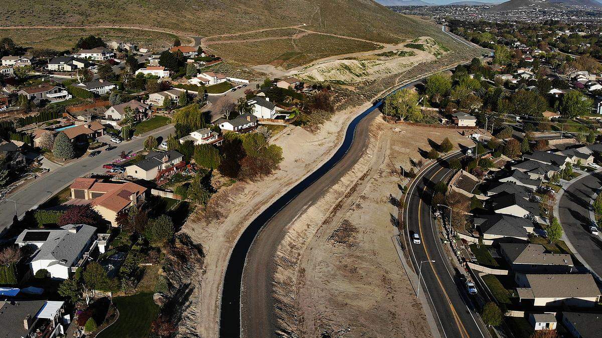 A KID irrigation canal runs along the base of Thompson Hill past Panoramic Heights and Creekstone housing developments in Kennewick. A proposal would redevelop 40 miles of Tri-City canals into walkable trails.