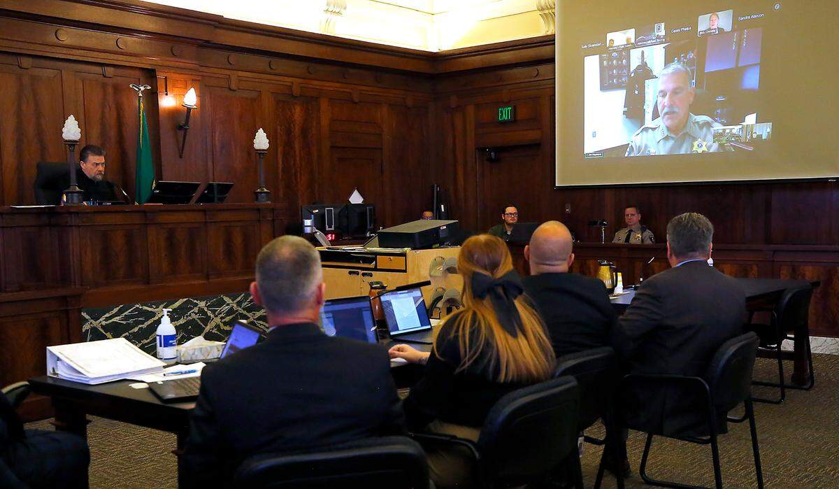 Sheriff Jim Raymond attends Thursday’s court hearing via a video link from his office.