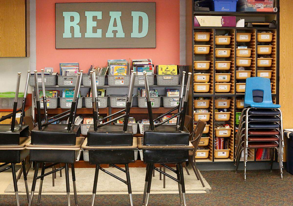 Unused student desks and chairs are stacked off to the side in this Pasco elementary classroom because of remote learning protocols in place during the ongoing coronavirus pandemic.