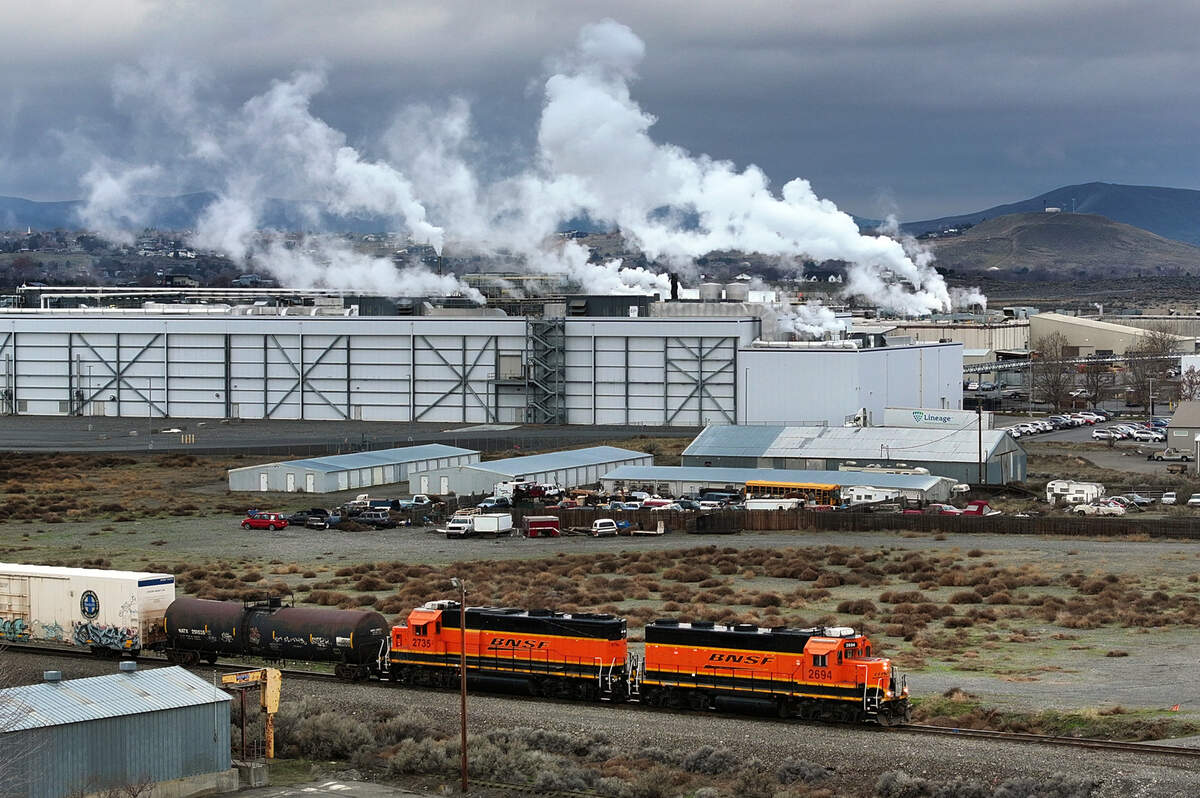 A train makes it way past the Lamb Weston processing plant in Richland.