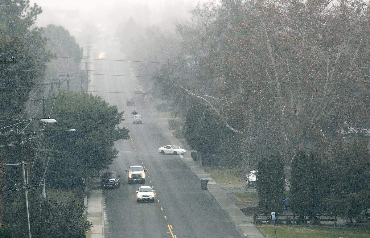 Snow flurries fill the air as it begins falling Tuesday afternoon near South Garfield Street in Kennewick. Not much snow is expected to accumulate.